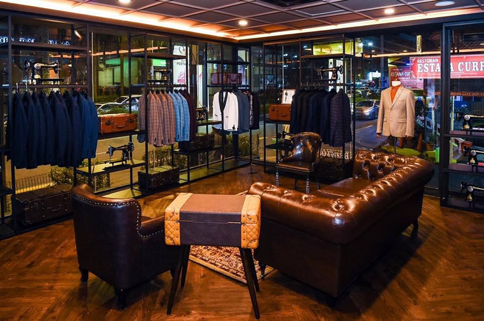 The JUNGLE Bespoke fitting room with leather sofa and suit racks
